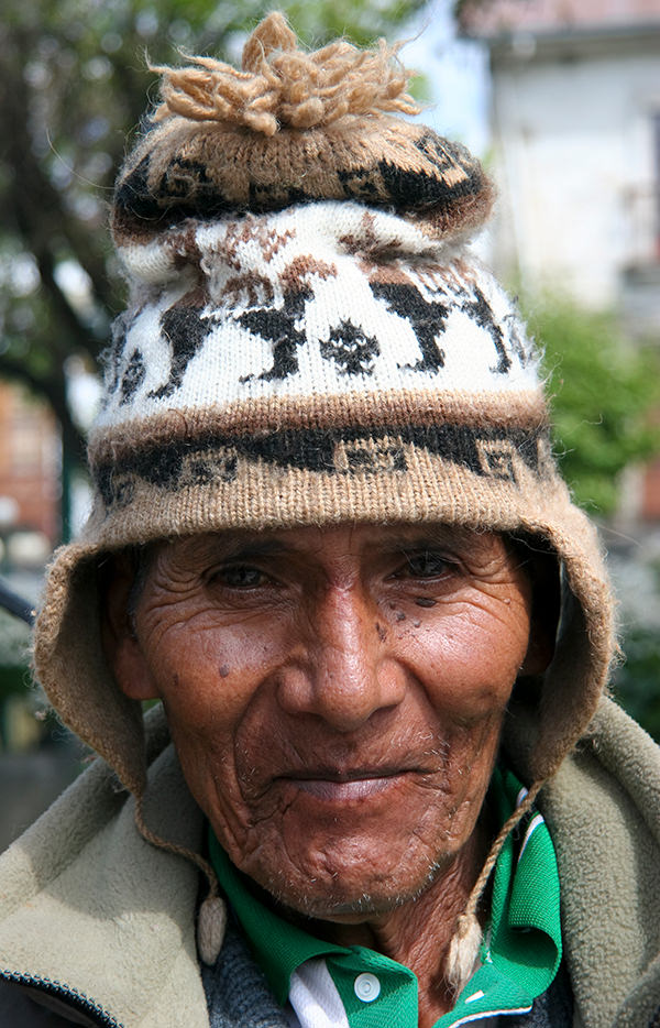 Close up portrait of a senior men posing in the suburb district of La Paz. La Paz is the administrative capital of Bolivia, as well as the departmental capital of the La Paz Department, and the second largest city in the country (in population) after Santa Cruz de la Sierra